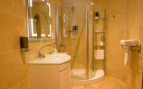 ein Badezimmer mit Dusche und Waschbecken in der Unterkunft Zimansky Hotel in Accra