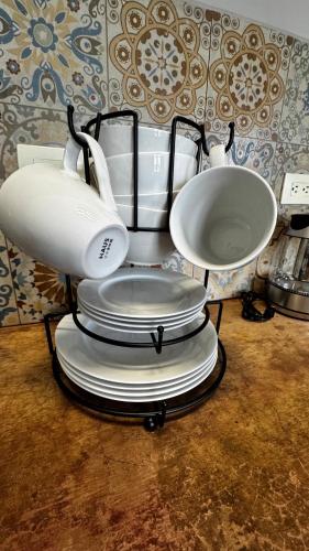 a white blender sitting on top of a stack of plates at Departmento en Barrio Antiguo in Monterrey