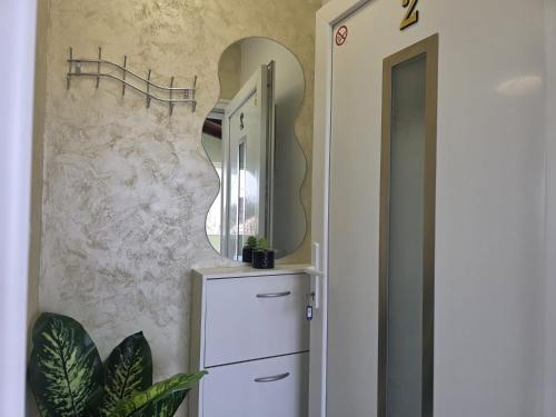 a dressing room with a mirror and a dresser at Pomerino Apartmans in Pomer