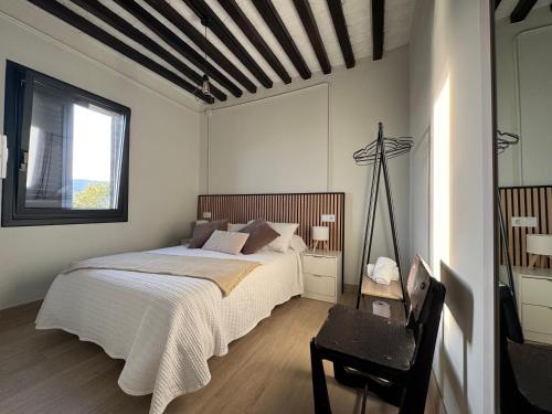 a bedroom with a large bed and a window at Casa Cuartel in Redondela