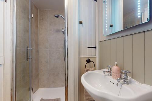 a bathroom with a sink and a shower at The Barn Timberscombe in Timberscombe