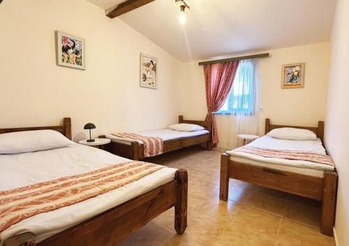 a bedroom with two beds and a window at Арт Спектър Камп in Bratsigovo