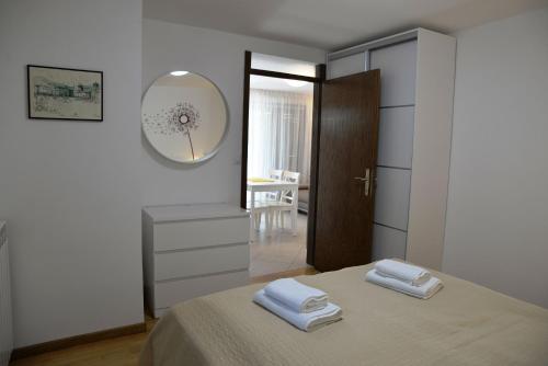 a bedroom with a bed with two towels on it at Apartments Marija in Cres