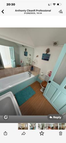 a bathroom with a bath tub and a sink at The lodge in Bodmin