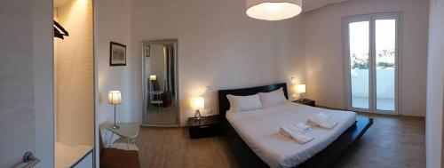 a bedroom with a large bed with towels on it at Flat via Irlanda 26 in Quartu Sant'Elena