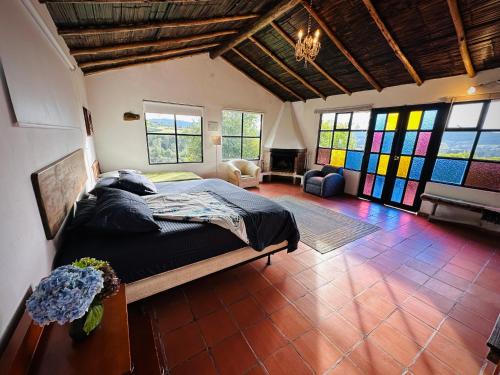 a bedroom with a bed and stained glass windows at Antara House in Guasca