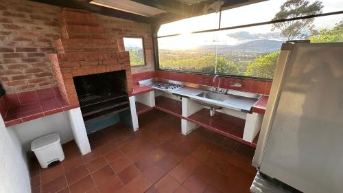 a bathroom with a fireplace and a sink and a window at Antara House in Guasca