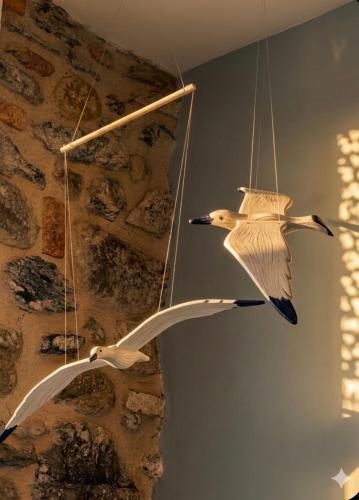 two birds are hanging from a wall at Silver Flat in Vernazza