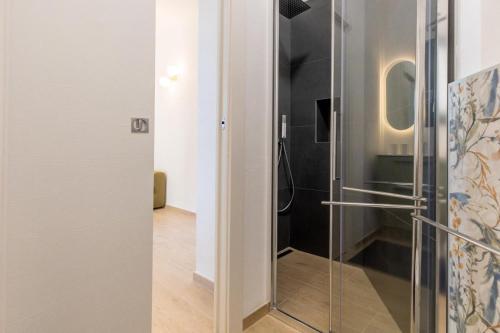 a bathroom with a shower with a glass door at Gli Oleandri in Bellano