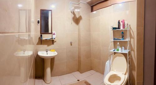 a bathroom with a toilet and a sink at Attic Hotel in Chachapoyas