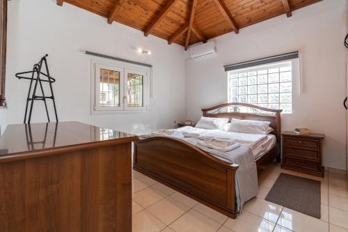 a bedroom with a bed and a desk in it at Zafeiris House in Kalívia Thorikoú