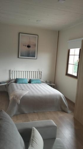 a bedroom with a large bed and a window at Solapetxea Loft rural in Elosu