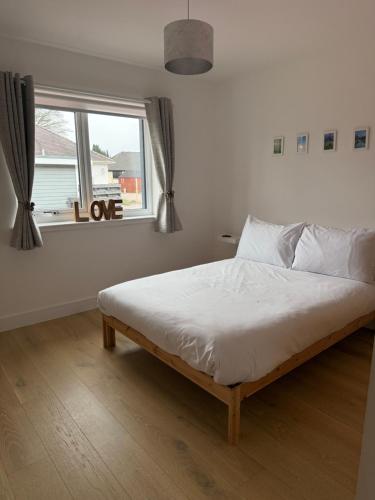 a bed in a bedroom with a window at Gili Taigh in Fort William