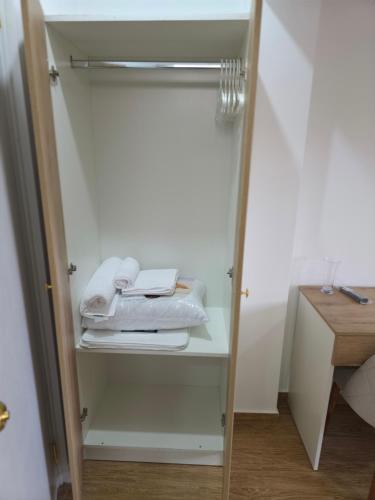 a closet with white towels on a shelf at Villa Arcadia Hotel & Eventos Cusco in Cusco