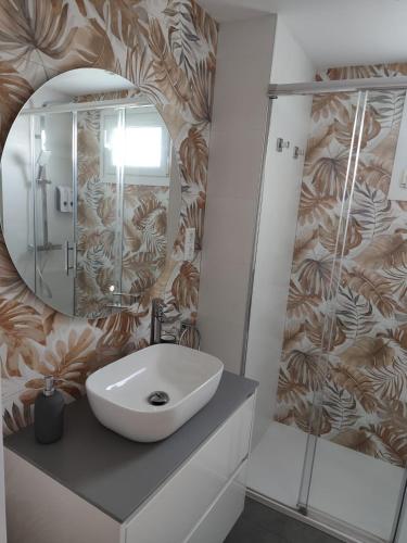 a bathroom with a sink and a mirror at Blue Ocean Apartments in Benalmádena