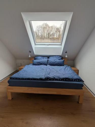 a bed in a room with a window at LechApartments in Kaufering