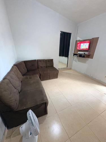 a living room with a couch and a flat screen tv at Casa de fundo aconchegante 4 solteiros ou 5 se 2 pessoas na casal in Campinas