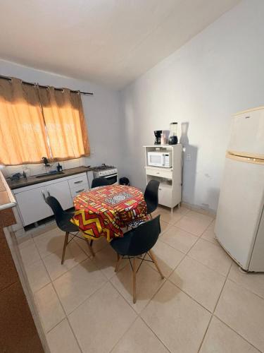 a kitchen with a table and chairs and a refrigerator at Casa de fundo aconchegante 4 solteiros ou 5 se 2 pessoas na casal in Campinas