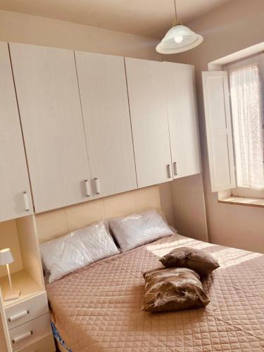 a bedroom with a bed with white cabinets at Alloggio nel Borgo Marinaro in Cittadella del Capo