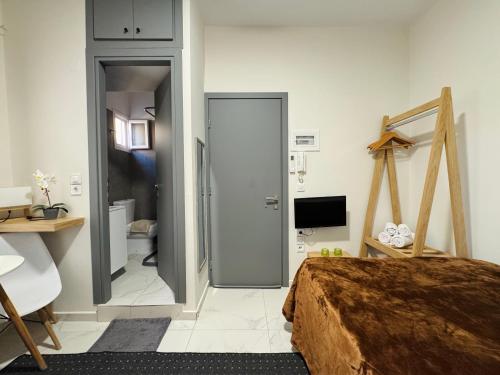 a bedroom with a bed and a door to a bathroom at The Central Retreat 4 in Mytilene