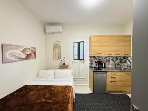a small room with a bed and a kitchen at The Central Retreat 4 in Mytilene