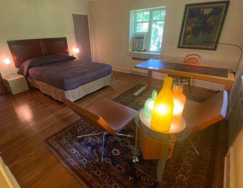 a bedroom with a bed and a desk and a table at 2 Born Wealthy in 1926 in Elkins Park