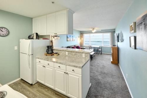 a kitchen with a refrigerator and a living room at Sea Gypsy Rentals in Lincoln City