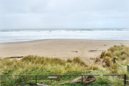 a sandy beach with the ocean in the background at Sea Gypsy Rentals in Lincoln City