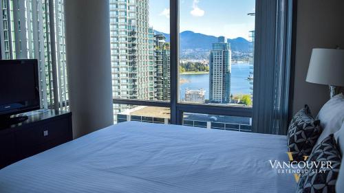 a bedroom with a large bed and a large window at Vancouver Extended Stay in Vancouver