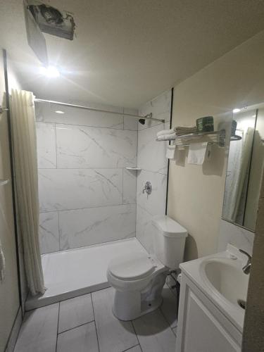 a bathroom with a shower and a toilet and a sink at Del Rancho Motel in Portland