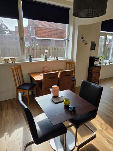 a dining room with a wooden table and chairs at Heerlijk dromen in 't Maantje in Waalwijk