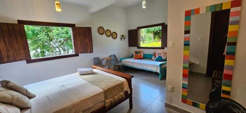 a bedroom with two beds and a couch in it at Sítio Roda d'Água in Lagoa Santa