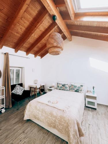 a bedroom with a large bed and a wooden ceiling at A Casa da Mariana in Casa Nova