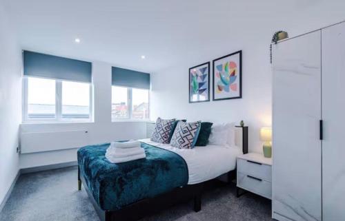 a white bedroom with a bed and a window at 1 Bedroom Luxury Apartment Winkley Square in Preston