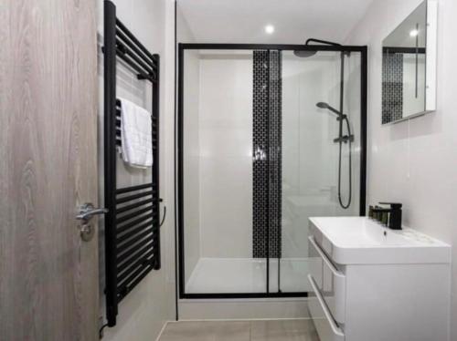 a bathroom with a shower and a white sink at 1 Bedroom Luxury Apartment Winkley Square in Preston