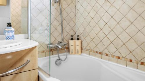 a bathroom with a shower and a sink and a tub at Casa Bellevue in Beausoleil
