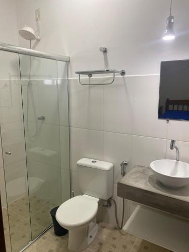 a bathroom with a shower and a toilet and a sink at Chacara pais e filhas in Socorro