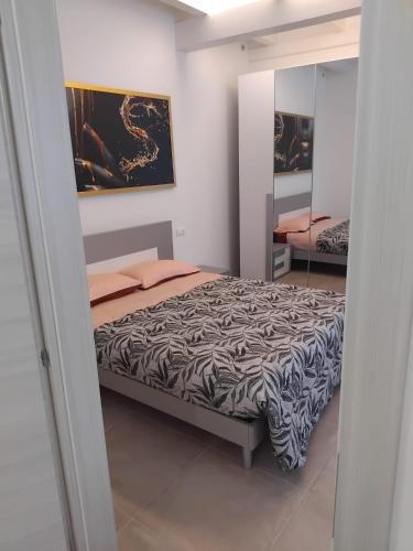 a bedroom with a bed and a mirror at La Tavernetta delle Terme Euganee in Montegrotto Terme