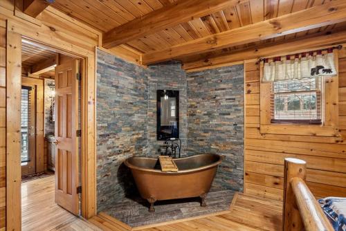 a wooden bathroom with a tub in a room at Beary Cozy Cabin by Venture Smoky Mountains in Sevierville