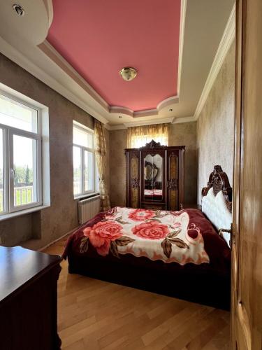 a bedroom with a large bed with roses on it at Fireside Fiesta Haven in Maglaki