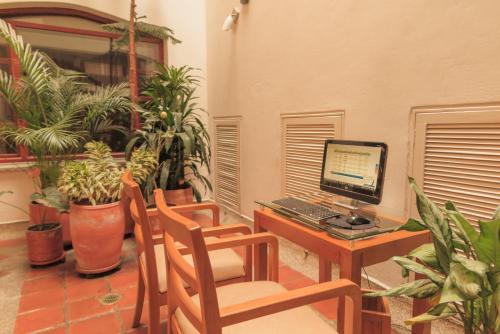 a room with a desk with a computer on it at Hotel Casa Deco in Bogotá