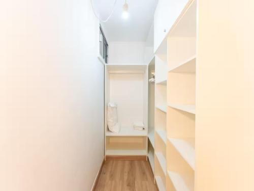 a walk in closet with white shelves at 1 BR Condo Chapelas Costa del Silencio AC Pool WIFI in Arona