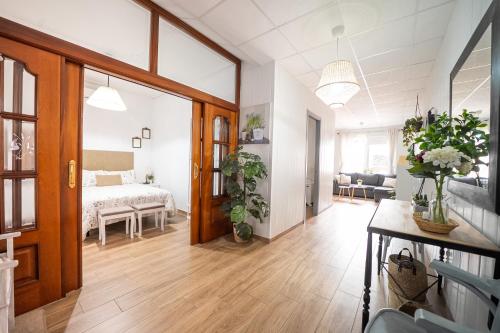 a room with a bed and a living room with a table at Casa tradicional Torrevieja in Torrevieja