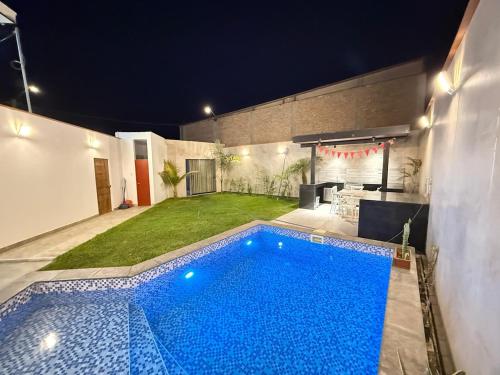 a swimming pool in the backyard of a house at Pool house, garden, grill in Ica