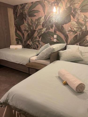 a room with two beds and a wall with plants at Venus Casa in Solt