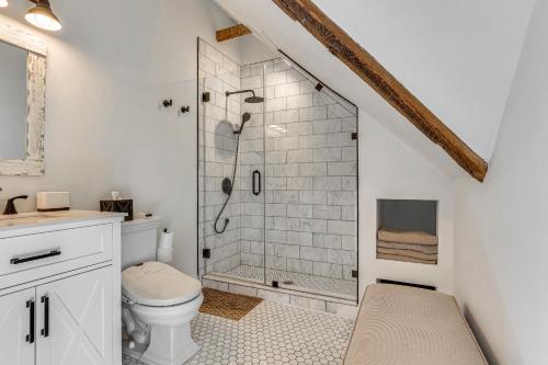 a bathroom with a shower and a toilet at Steps to NYC Train! Charming Carriage House Loft in Glen Ridge