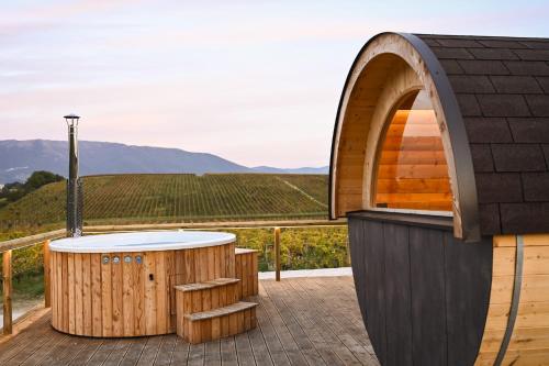 a soak in a hot tub on the deck of a winery with a view at Ámpelos Wine Room in Gallo