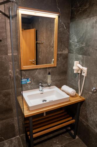 a bathroom with a sink and a mirror at Liptov Hills in Liptovský Mikuláš