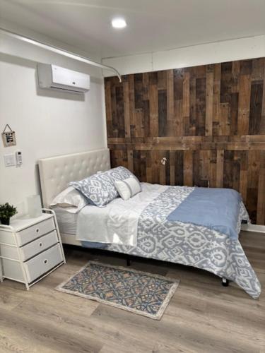 a bedroom with a bed and a wooden wall at dary hause in Indianapolis