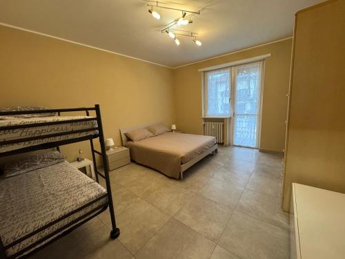 a bedroom with two bunk beds and a window at Great Sweet Home in Strambino